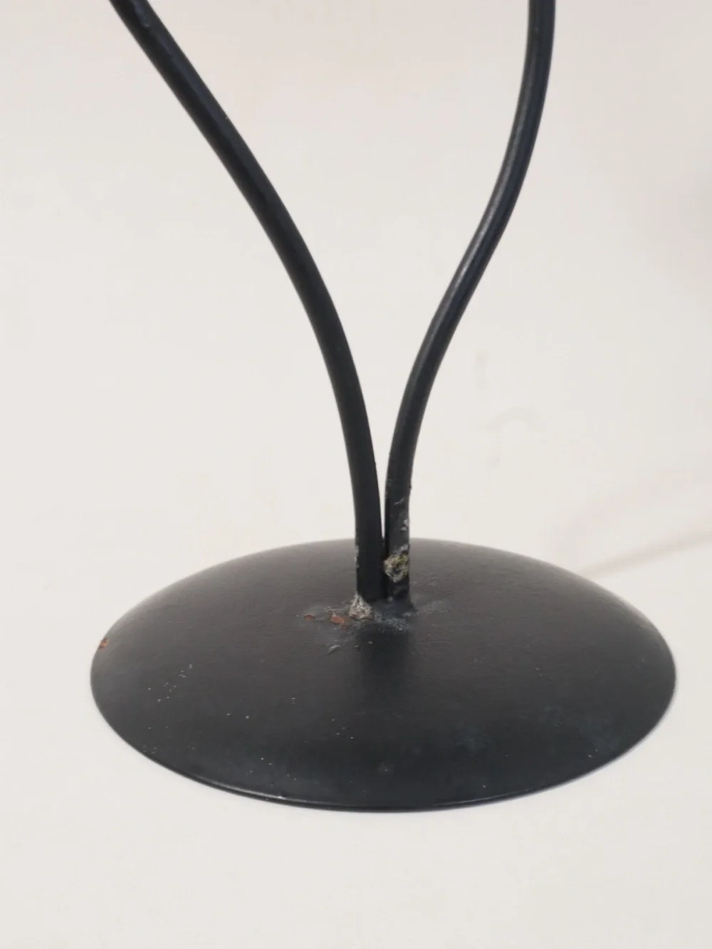 Vintage postmodern black metal double candle holder with a scrollwork design